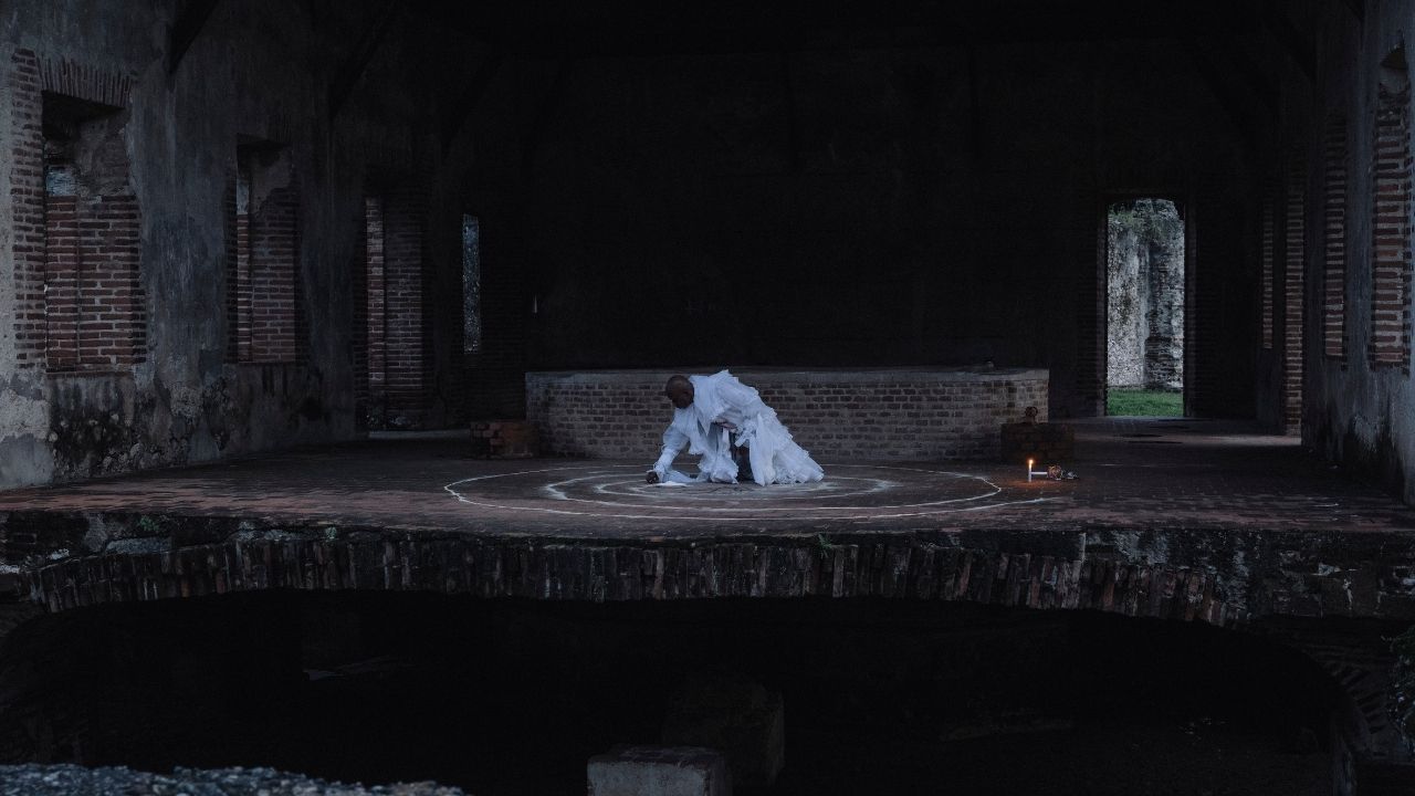 a person in white drawing circles with chalk